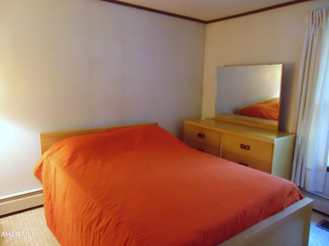 bedroom featuring baseboard heating and ornamental molding