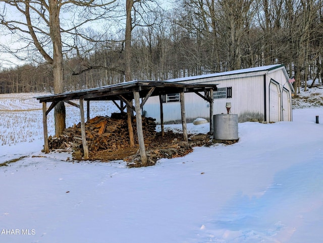 snowy yard featuring a garage