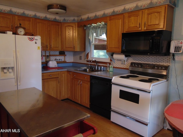 kitchen with backsplash, light hardwood / wood-style flooring, black appliances, and sink