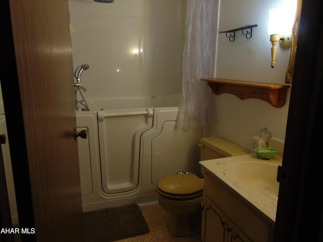 bathroom featuring toilet, a shower, tile patterned floors, and vanity