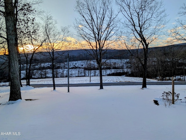 snowy yard featuring a mountain view