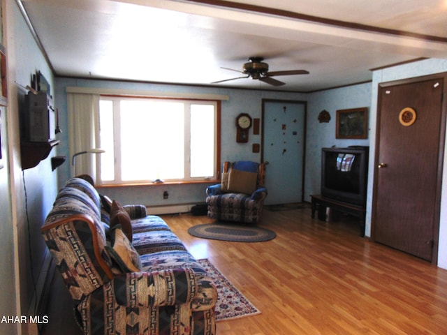 living room with baseboard heating, hardwood / wood-style floors, ceiling fan, and ornamental molding