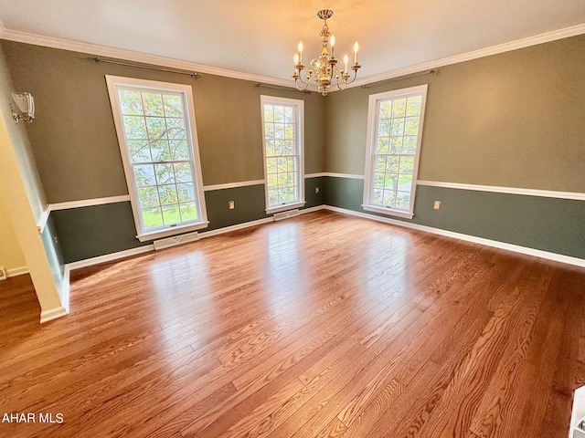 unfurnished room with a chandelier, light hardwood / wood-style floors, and ornamental molding