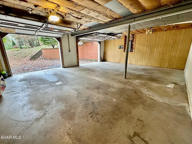 garage featuring electric panel and a garage door opener