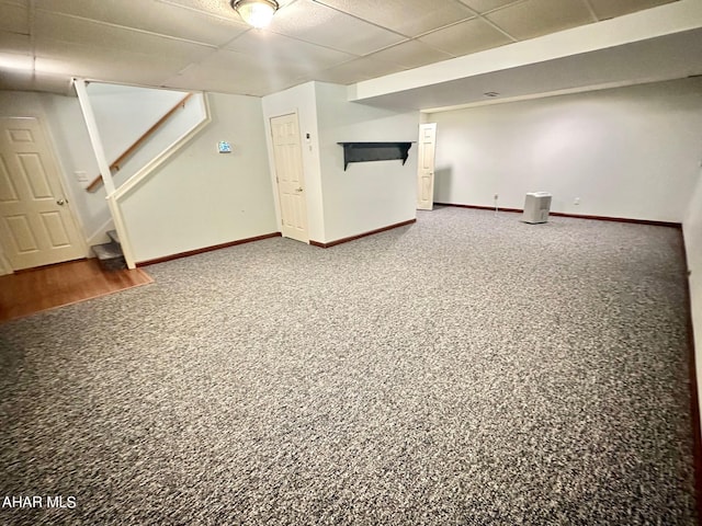 basement featuring carpet flooring and a drop ceiling