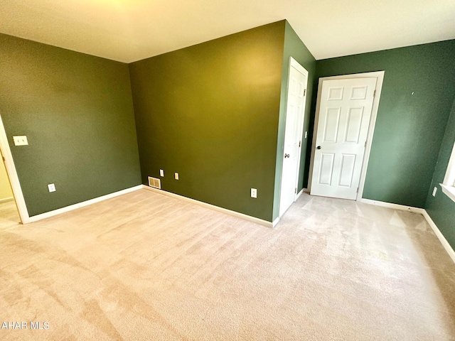 spare room with light carpet