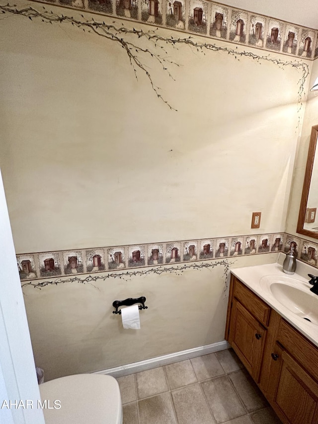 bathroom featuring tile patterned flooring, vanity, and toilet