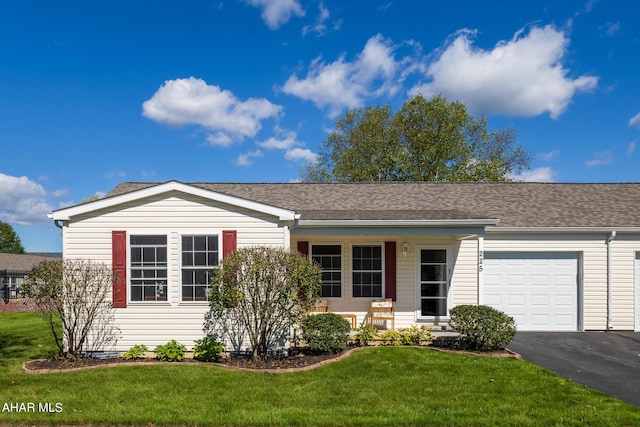 ranch-style home featuring a front lawn and a garage