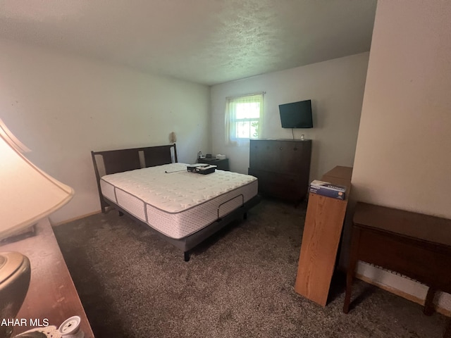 carpeted bedroom featuring a textured ceiling