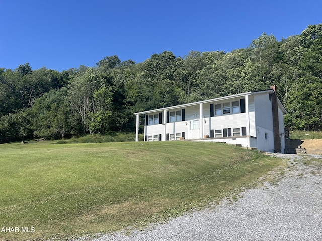 raised ranch featuring a front yard