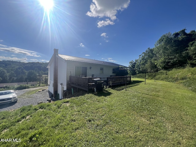 exterior space featuring a deck and a lawn