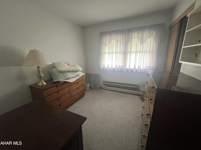 carpeted bedroom with a baseboard heating unit