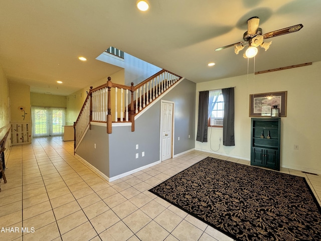 interior space with light tile patterned floors, ceiling fan, and cooling unit