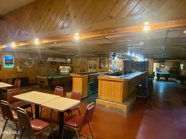 interior space featuring bar, wooden walls, and pool table