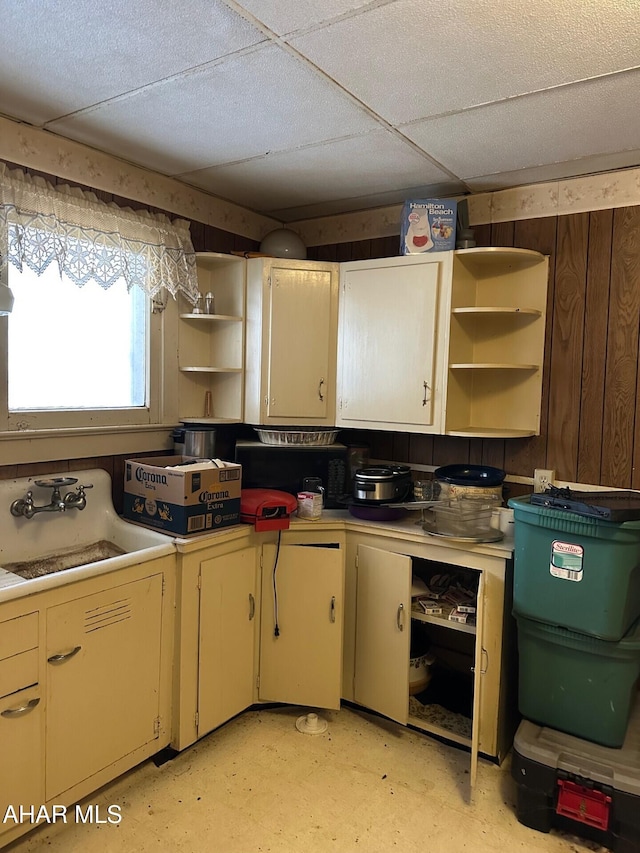 kitchen featuring a paneled ceiling and sink