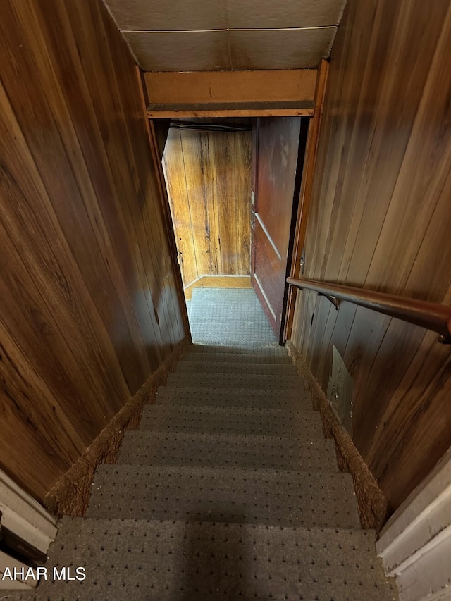 stairs with wooden walls and carpet