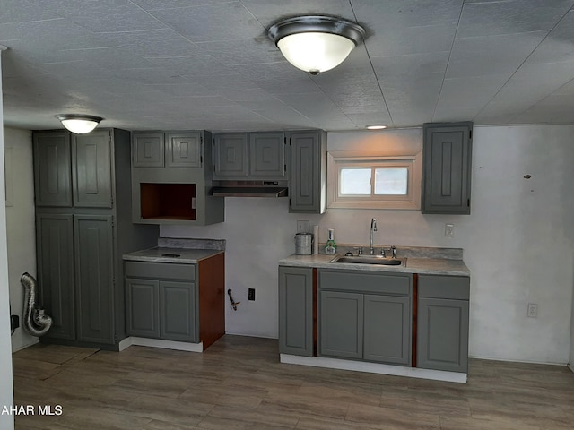 kitchen with gray cabinetry and sink