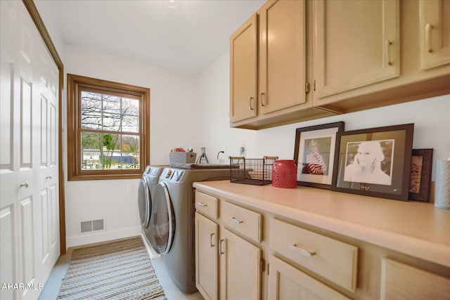 laundry area with cabinets and washing machine and dryer