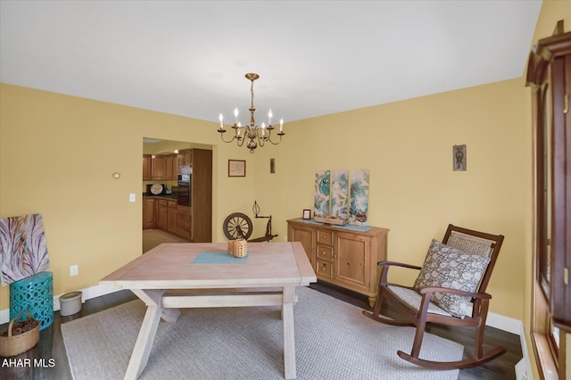 dining room featuring hardwood / wood-style flooring and a chandelier