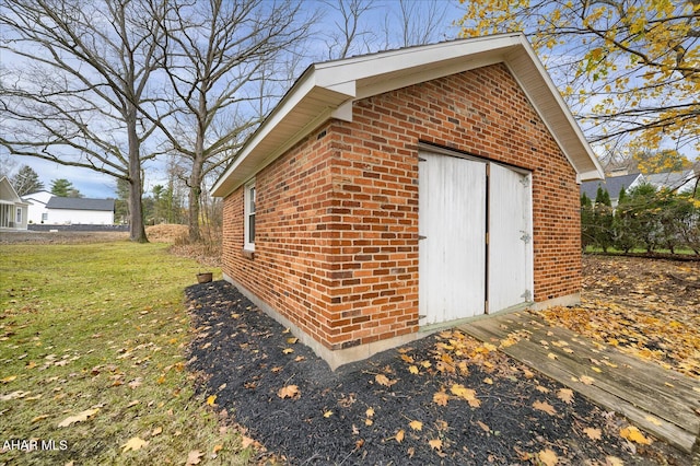 view of outbuilding featuring a lawn