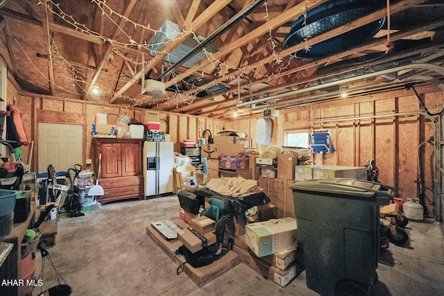 garage featuring white fridge with ice dispenser