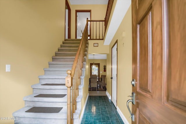 entryway with dark tile patterned flooring