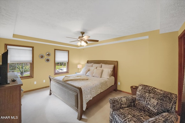 carpeted bedroom with a textured ceiling and ceiling fan