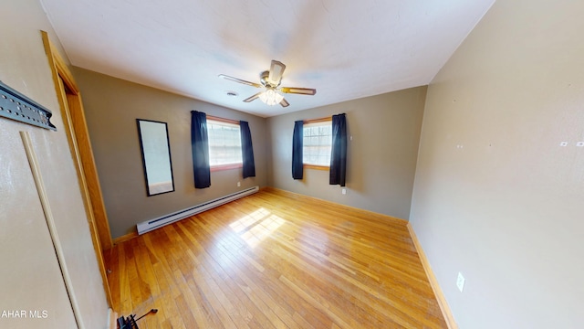 unfurnished bedroom featuring hardwood / wood-style floors, ceiling fan, baseboards, and a baseboard radiator