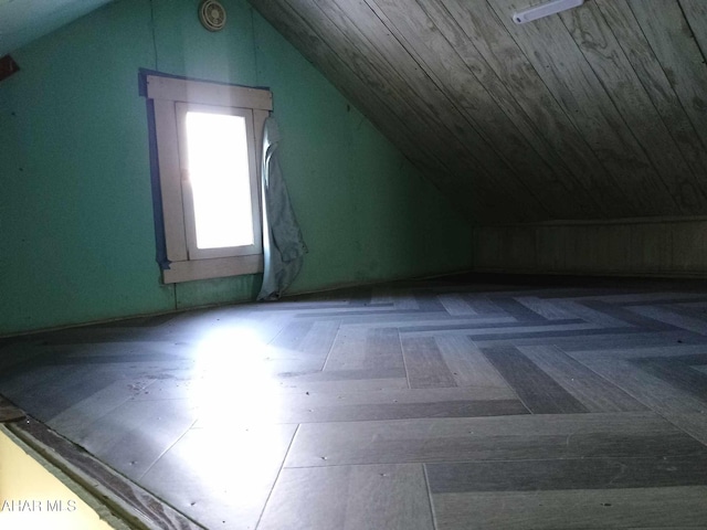 additional living space featuring lofted ceiling and dark parquet floors