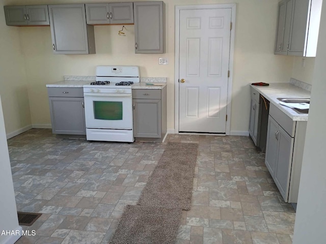 kitchen featuring gray cabinetry and white gas range