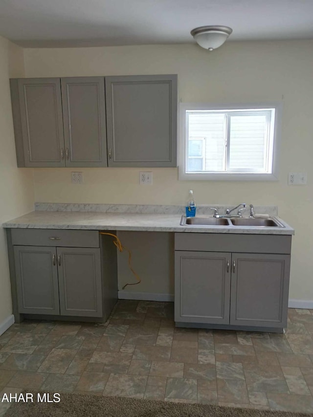 kitchen featuring sink and gray cabinets