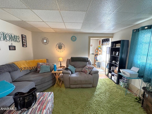 living room with a drop ceiling