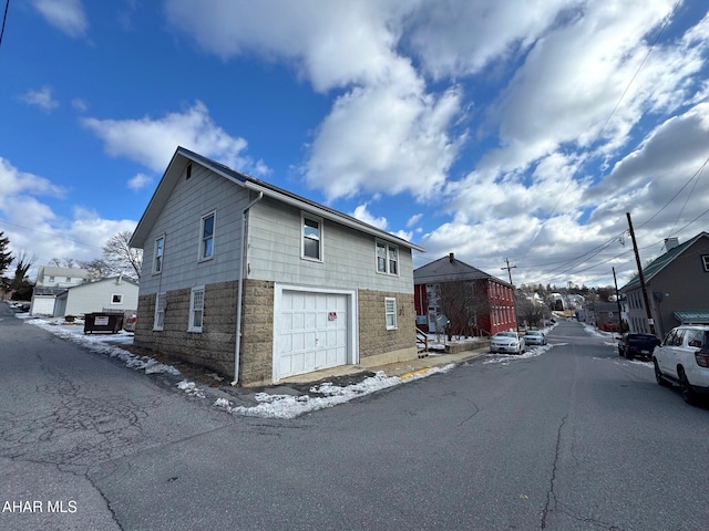 exterior space with a garage and a residential view