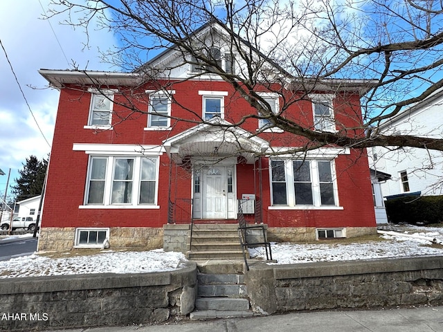 view of front of property with entry steps and brick siding