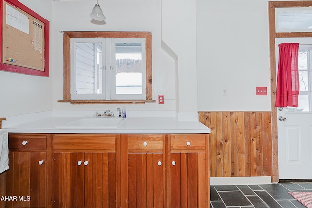 bathroom featuring vanity and wood walls