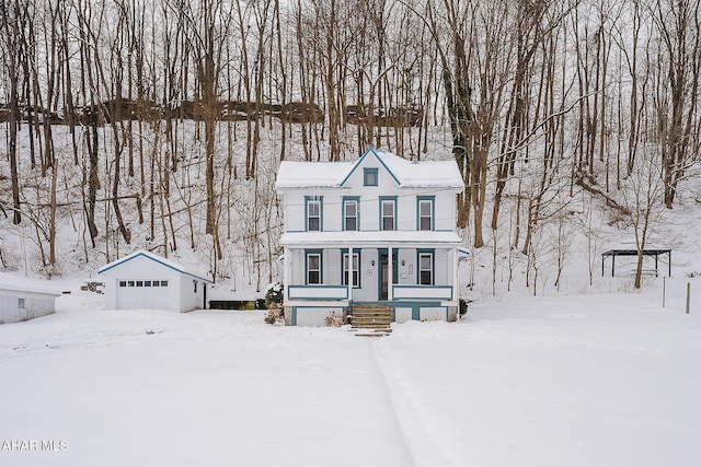 view of front of property with a garage and an outdoor structure