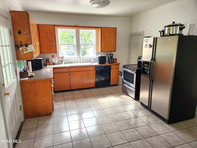 kitchen featuring sink, appliances with stainless steel finishes, and tasteful backsplash