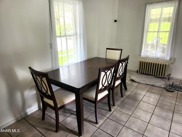 tiled dining space with radiator heating unit