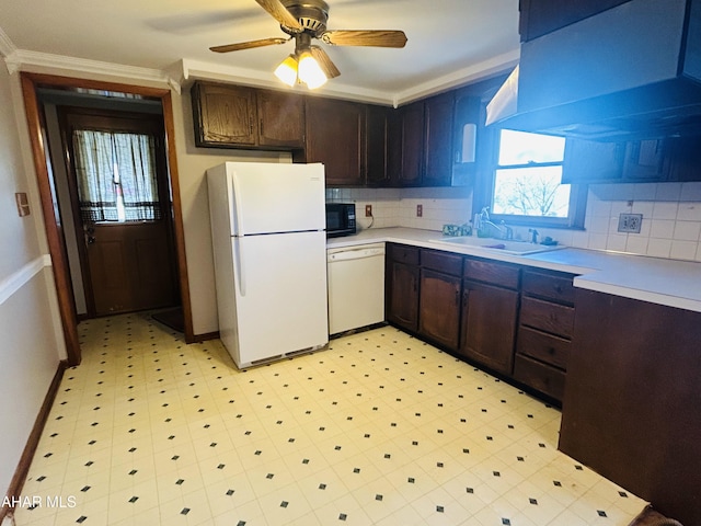 kitchen featuring dark brown cabinetry, decorative backsplash, sink, and white appliances