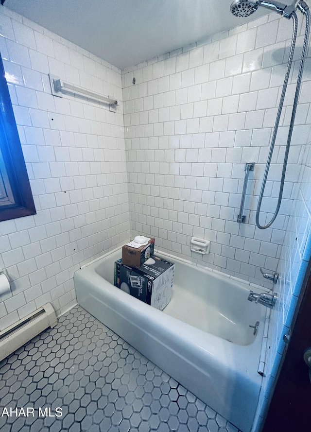 bathroom with a baseboard radiator, tile patterned floors, and tiled shower / bath