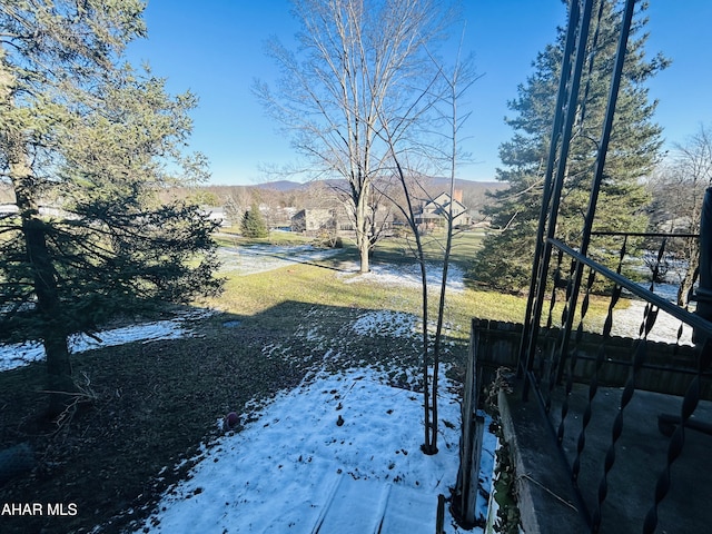 snowy yard featuring a mountain view