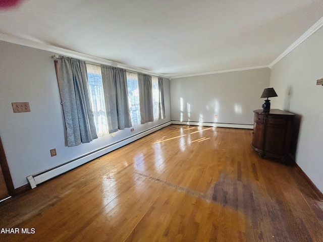 interior space with hardwood / wood-style flooring, ornamental molding, and baseboard heating