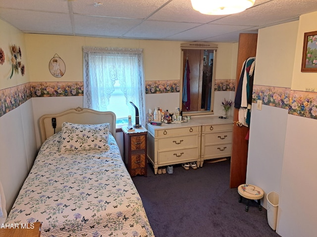 bedroom with a paneled ceiling and carpet