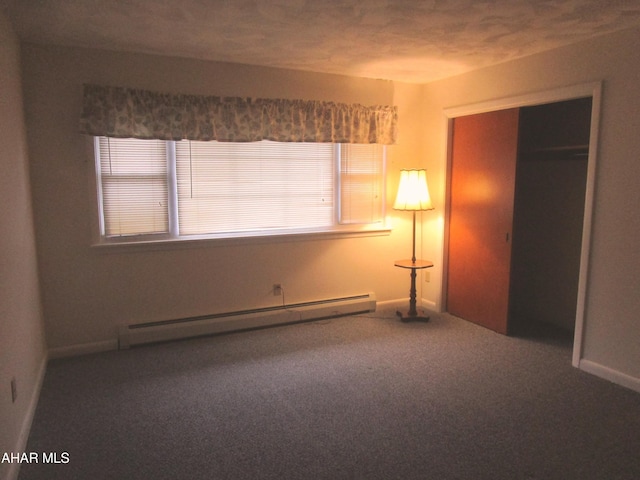 unfurnished bedroom featuring a closet, carpet floors, and a baseboard radiator