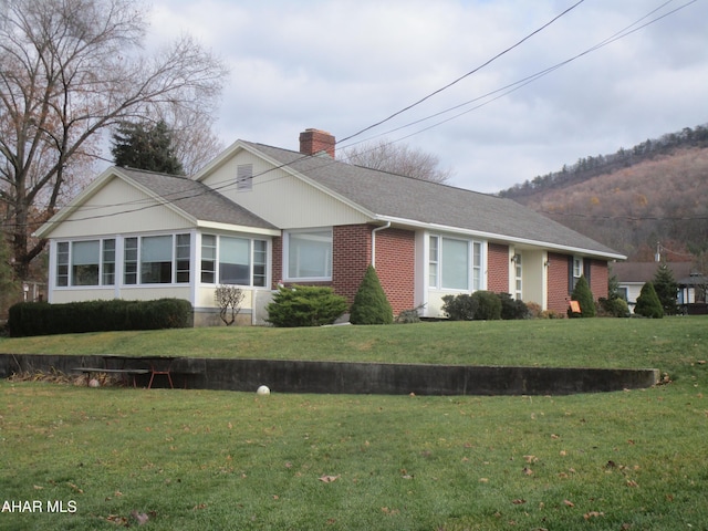 ranch-style home featuring a front yard