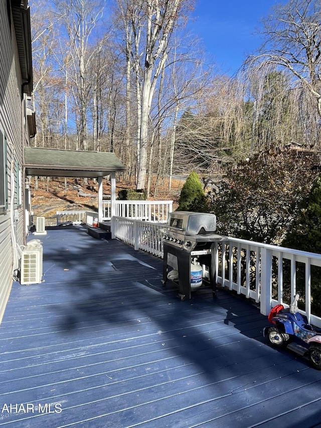 wooden deck with area for grilling and central AC