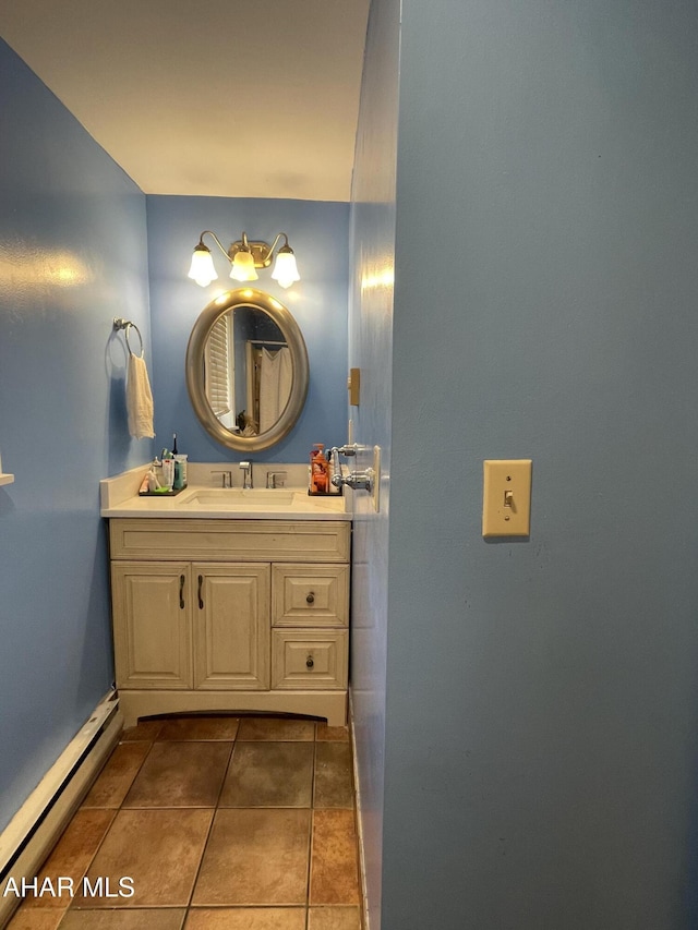 bathroom with vanity, a baseboard radiator, and tile patterned floors