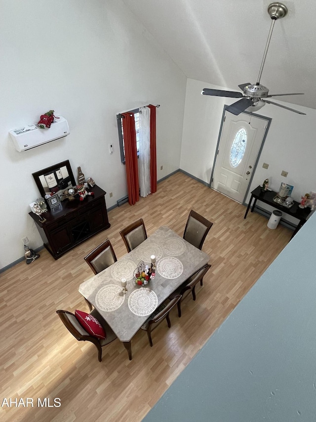 dining area featuring ceiling fan, hardwood / wood-style floors, and vaulted ceiling