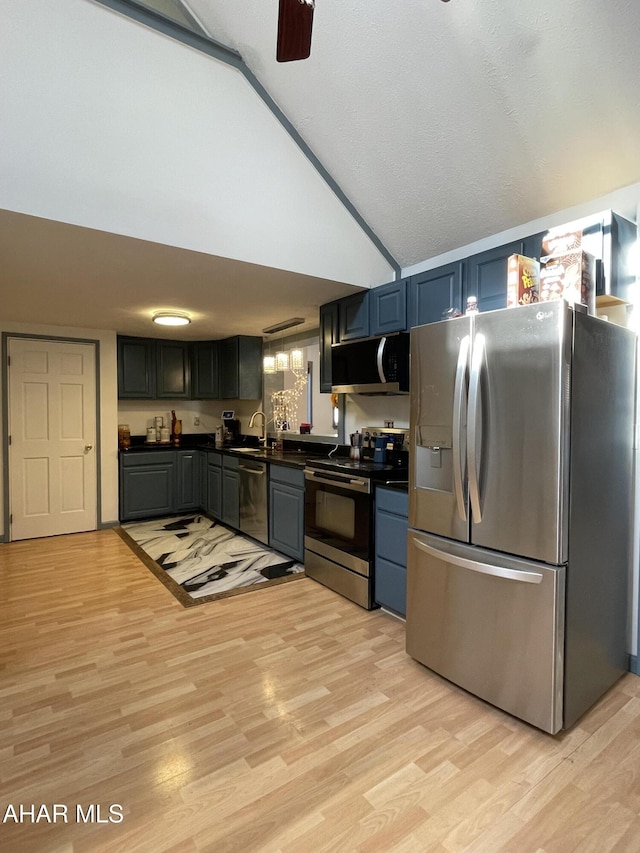 kitchen with light hardwood / wood-style flooring, high vaulted ceiling, stainless steel appliances, and sink