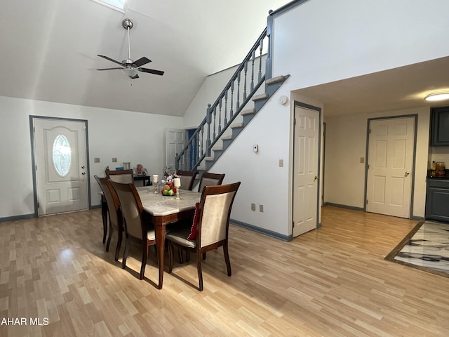 dining room featuring ceiling fan, light hardwood / wood-style flooring, and vaulted ceiling